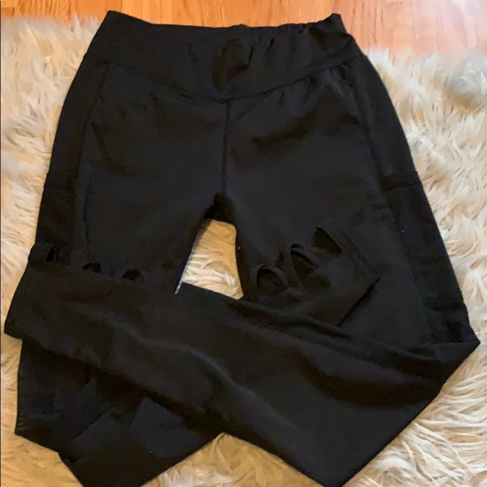 Black workout leggings with lace and cutouts.